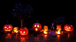 carved pumpkins lit up at night